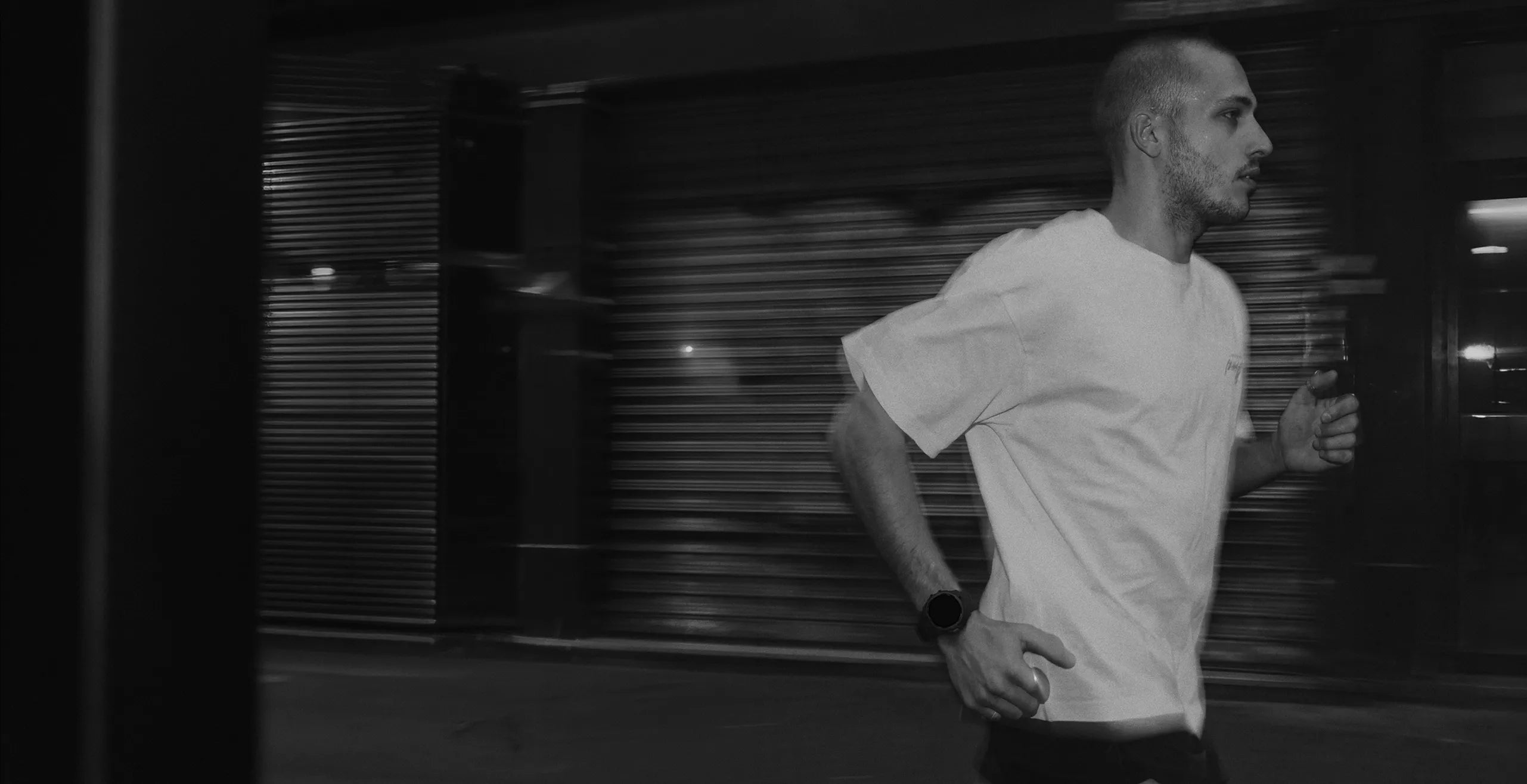 Man running on city street in monochrome filter for endurance training | Polar Philippines