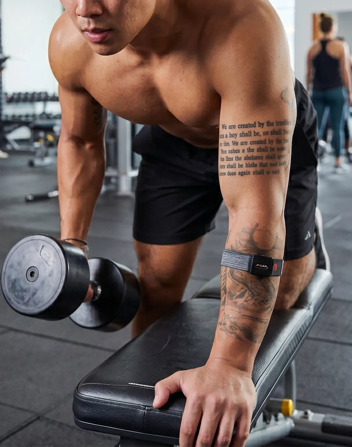 Man lifting a dumbbell in the gym while wearing a heart rate monitoring sensor | Polar Philippines