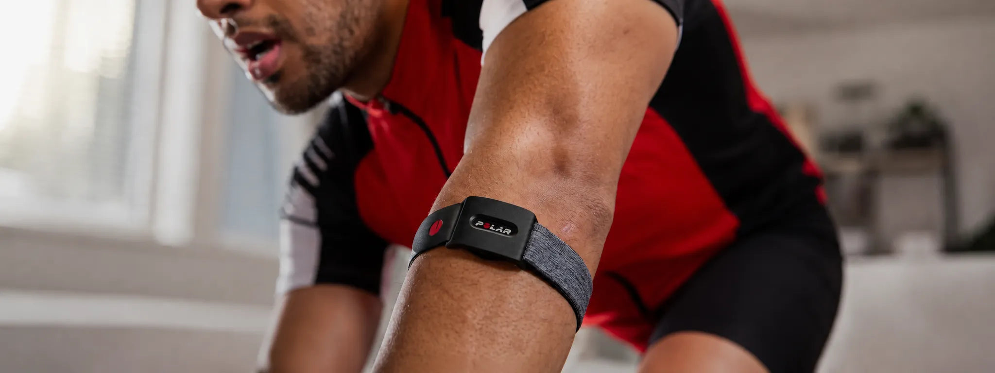Cyclist wearing a heart rate monitoring sensor while riding on a road outdoors | Polar Philippines