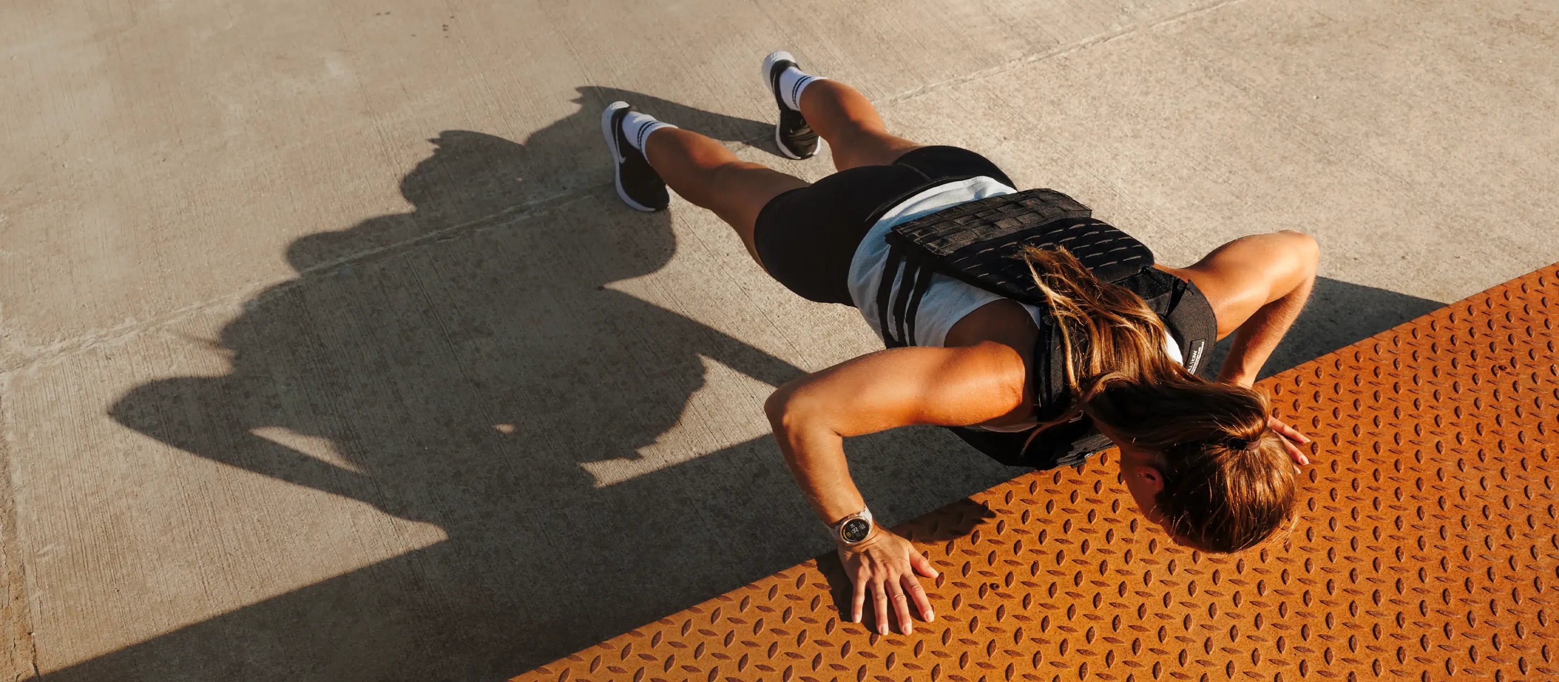 Athlete doing push-ups outdoors while wearing a Polar smartwatch | Polar Philippines