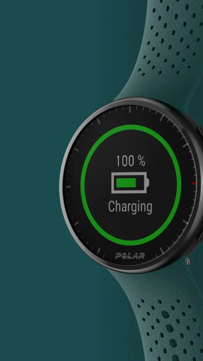 Smartwatch displaying 100 percent charging status with green progress ring on teal strap | Polar Philippines