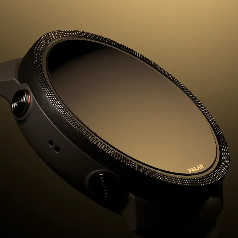 Close-up of smartwatch with textured bezel on warm gradient background | Polar Philippines