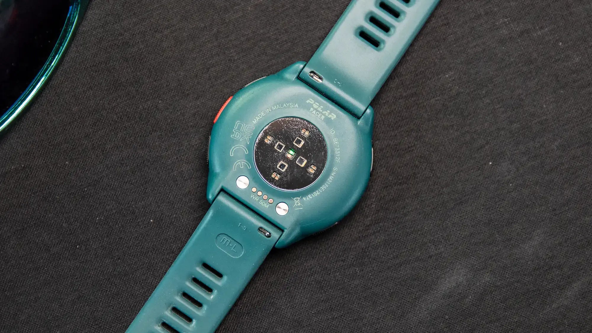 Back view of a smartwatch in Deep Teal colorway showcasing sensor technology | Polar Philippines