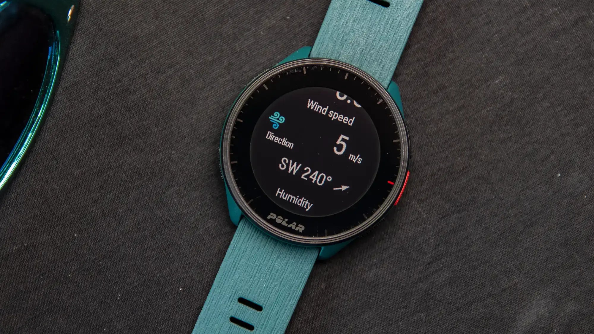 Smartwatch displaying wind speed and humidity data on a black mat background | Polar Philippines