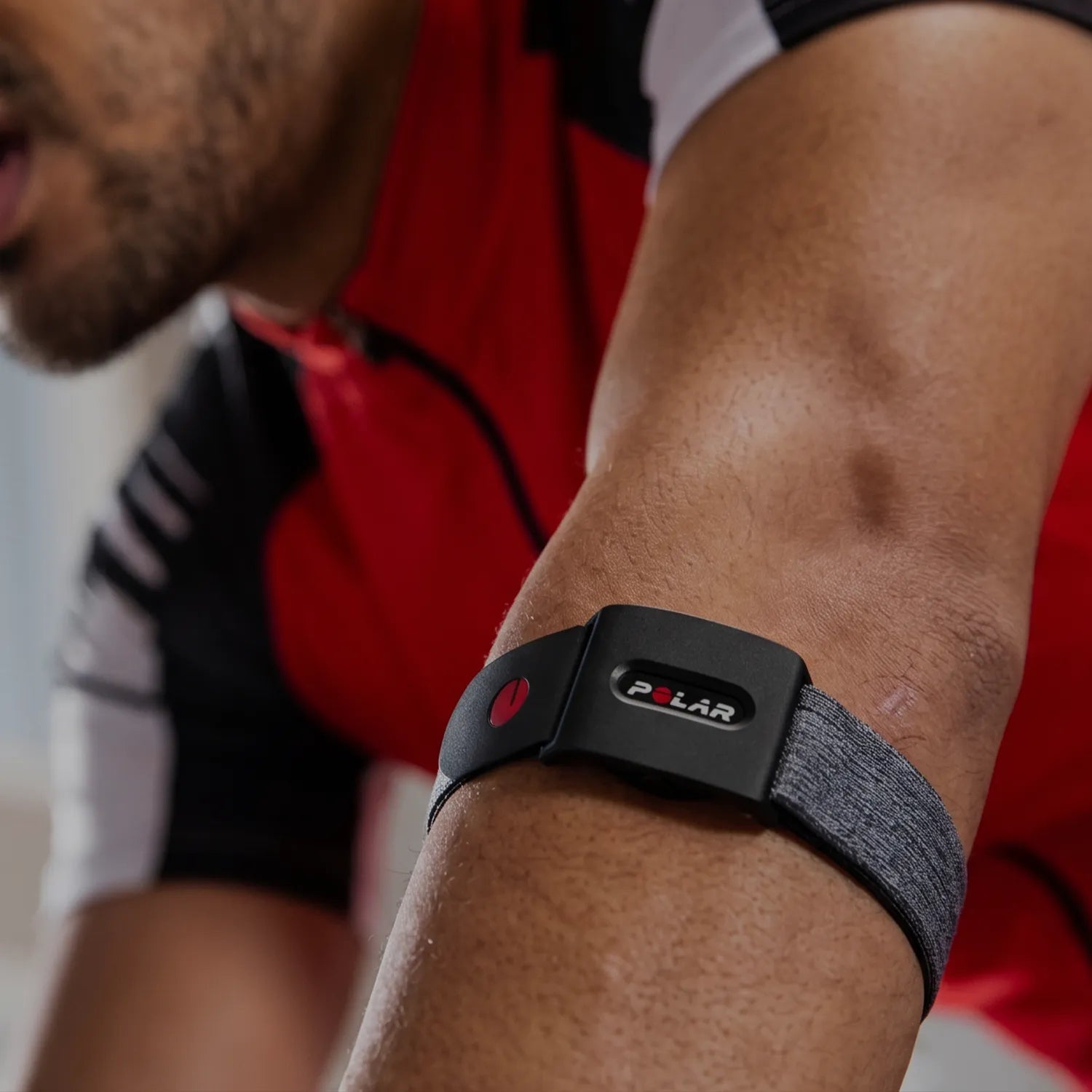 Cyclist wearing a heart rate monitoring sensor while riding on a road outdoors | Polar Philippines
