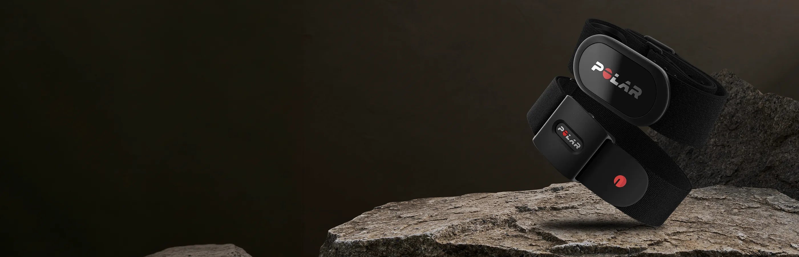 Two optical heart rate monitors displayed on a rock with a dark brown background | Polar Philippines